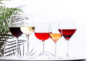 Non-alcoholic, alcohol free wine set. Red, white, rose wines in glasses. White background, shadows,...