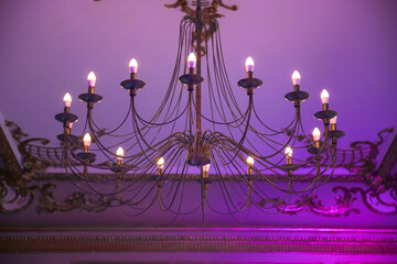 Luxury, expensive chandelier hanging under ceiling