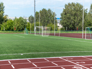 Red treadmill at the stadium with white lines