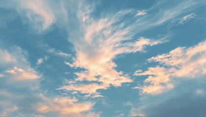 Obraz premium Vibrant clouds stretch across a bright blue sky during early evening hours