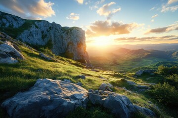 Sunset over majestic mountains, lush green valley, and rocky terrain