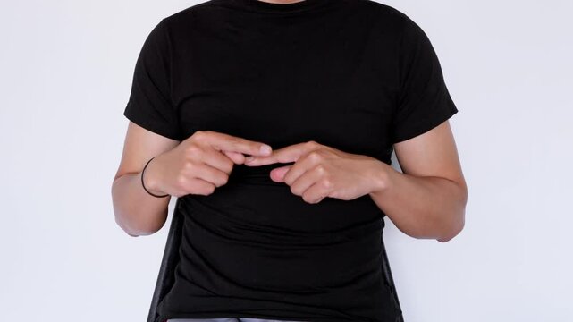 Sign language for "next." Man wearing a black polo shirt sitting on a white background.