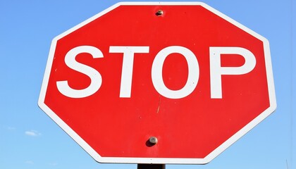 Obraz premium Stop Sign with Clear Blue Sky Background 