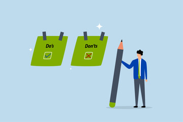 Do and don't checklist, businessman write do and don't checklist on sticky notes.