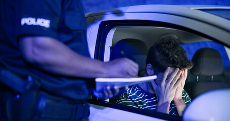 Traffic stop, man and frustrated in car with police, lights and stress for drunk driving or...