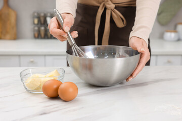 Woman making dough at white marble table indoors, closeup