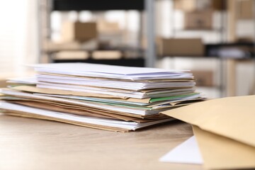 Many different envelopes on table in post office