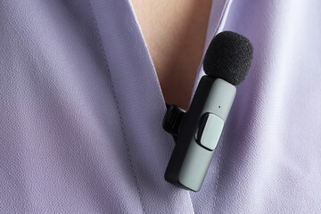 Woman with lavalier microphone on her shirt, closeup