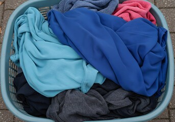 Laundry basket full of colorful clothes after wash