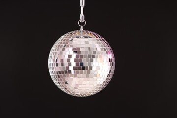 One shiny disco ball on black background