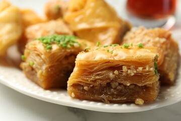 Tasty Turkish baklava on white table, closeup