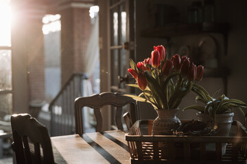 vase of tulips on a table in the morning light