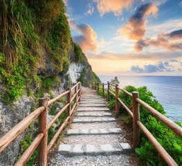Obraz premium A stone pathway leads up a cliffside towards the horizon where the ocean meets the sky at sunset