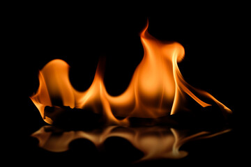Captivating Flames Dance in Darkness with Reflections on Surface