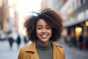 Obraz premium Portrait of a smiling young African American woman in city