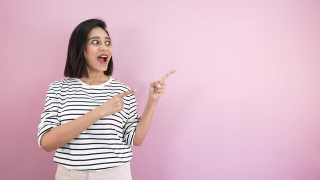 girl pointing fingers at side showing commercial advertisement empty copy space with excitement face