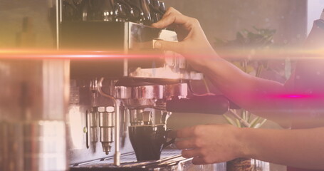 Image of glowing moving lights over coffee machine