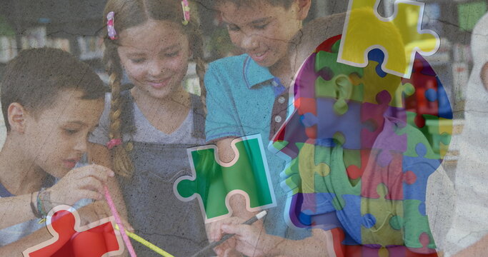 Image of puzzle pieces over diverse schoolchildren