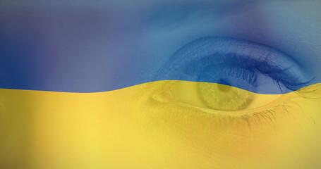 Image of flag of ukraine waving over open eye of caucasisan woman