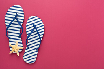 Striped blue flip flops on color background, top view