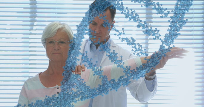 Image of dna strand over caucasian male doctor treating senior female patient - Powered by Adobe