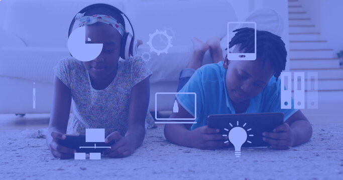 Image of technology icons over african american siblings using technology