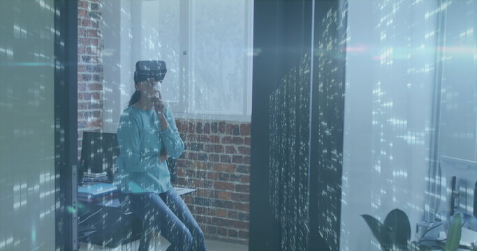 Image of data processing over caucasian businesswoman using vr headset