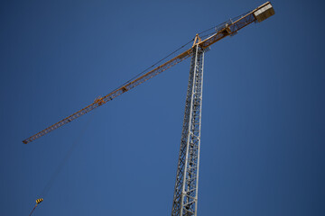 A Tower Crane Stands Against a Clear Blue Sky, Symbolizing Modern Construction Efforts