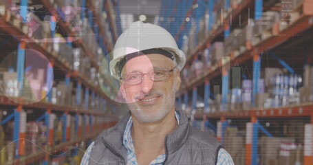 Image of statistics and data processing over smiling caucasian man working in warehouse