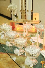 A Table Topped With Glass Bowls Filled With C