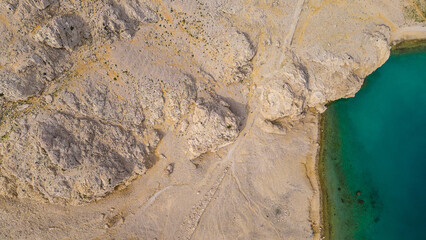 Aerial view of the famous Life on Mars Trail near Metajna on Pag Island, Croatia. Unique rocky landscape, dramatic coastline, and turquoise sea captured by drone. A paradise for hikers and nature love