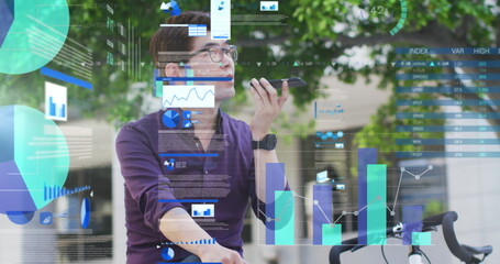 Image of asian businessman talking on smartphone over data processing