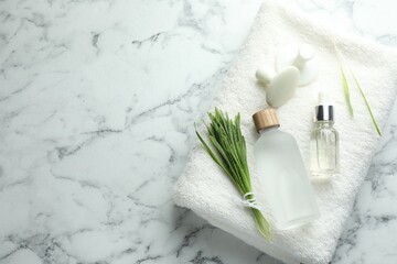 Spa composition with wheatgrass on white marble background, top view. Space for text