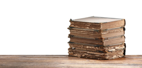 Old books on wooden table against white background
