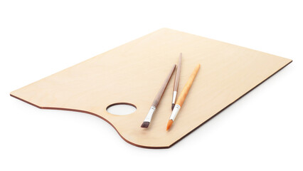 Wooden palette and brushes isolated on white