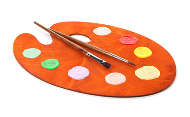 Wooden palette with paints and brushes isolated on white