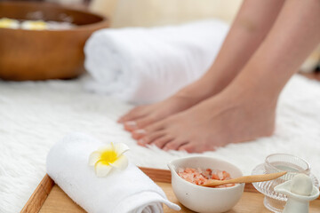 Panorama top view woman indulges in blissful foot massage at luxurious spa salon while masseur give reflexology therapy in gentle day light ambiance resort or hotel foot spa. Quiescent
