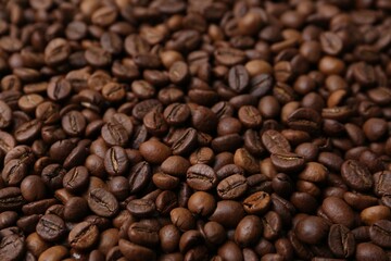 Pile of aromatic coffee beans as background, closeup