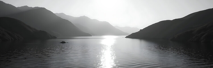 Obraz premium Rippling water surface is reflected in sunlight on a black and white monochrome landscape from high mountain vantage point._00001_