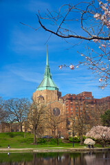 A Cleveland Ohio church popularly known as "the Holy Oil Can" because of its unique steeple, sits above Wade Lagoon in the University Circle district among flowering cherries.