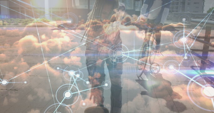 Image of data processing over clouds and biracial man skateboarding