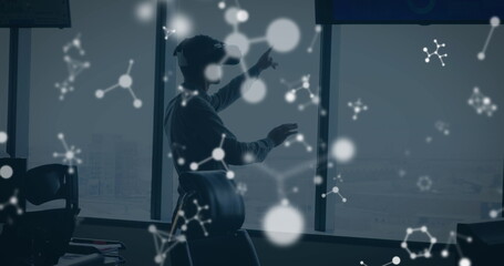 Image of shapes over caucasian man using vr headset