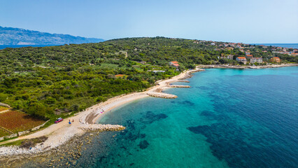 Aerial view of Cape Lun, the northernmost point of Pag Island, Croatia. Featuring the ancient Olive Gardens of Lun with thousands of centuries-old olive trees, rocky coastline, and stunning Adriatic