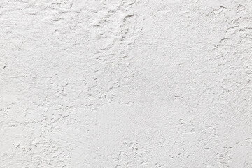 A white wall with a rough texture