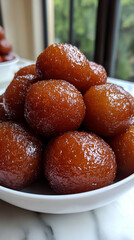 Close-up of golden Gulab Jamun soaked in syrup, symbolizing celebration, sweetness of life, and cultural richness in Indian and South Asian traditions, often served during joyful occasions.

