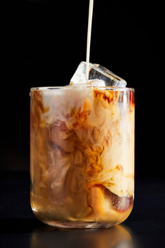 Coffee Pouring into a Glass on a Black Background
