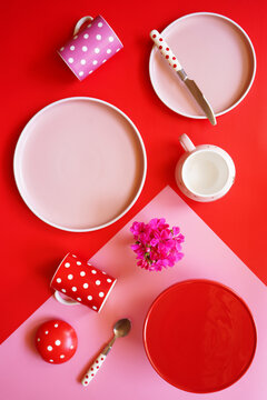 Pop art food, color blocking aesthetic table setting in modern pink and red theme.