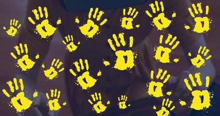 Image of handprints over caucasian woman using vr headset