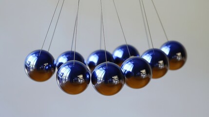 Mesmerizing Display of Physics in Motion with Cradle of Balls Showcasing Law of Conservation of Energy in Dynamic Action