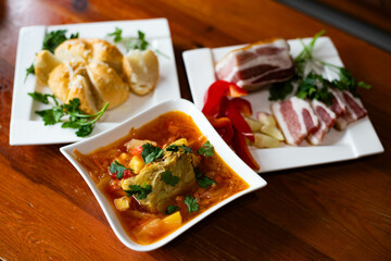 Traditional borscht with meat, salo and bread rustic homemade meal